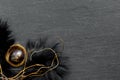 Black fur nest with painted eggs on a dark stone table. Festive Easter banner with branches. Concept design Royalty Free Stock Photo