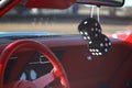 Black fuzzy dice hanging from the rear view mirror Royalty Free Stock Photo