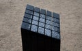 Black gabbro stone prism. it stands in the park and is bevelled and polished. if it gets wet, can play various sound melodies and