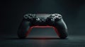 Black game controller illuminated with red light on dark surface Royalty Free Stock Photo