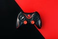 Black gamepad on a black red background, . Gaming concept