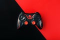 Black gamepad on a black red background, . Gaming concept