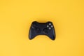 Black gamepad, controller on a yellow background. Computer game competition. Gaming concept Royalty Free Stock Photo