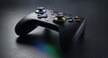 Black Gaming Controller with Colorful Buttons on Dark Surface Royalty Free Stock Photo