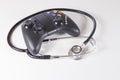 Black gaming controller and doctors stethoscope