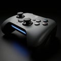 A black gaming controller sits on a dark surface, featuring dual analog sticks, a Royalty Free Stock Photo
