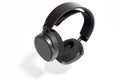 Black gaming headphones on white background. Floating headphones with a shadow