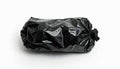 Black garbage bag on white backdrop. Isolated plastic waste container against blank background. Concept of rubbish disposal and Royalty Free Stock Photo