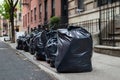 Black Garbage Bags along a Residential Street in Greenwich Village of New York City Royalty Free Stock Photo