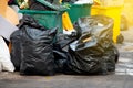 Black garbage bags at city street, waste management in large cities Royalty Free Stock Photo