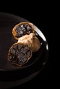 Black garlic on black plate