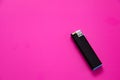 Black gas lighter on a purple background. Close-up surface for your design. Empty gas plastic lighter mockup element