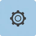 A black gear icon is centered on a light blue background. The gear has a circular inner Royalty Free Stock Photo