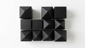 Black geometric shapes arranged in a grid pattern on a white background Royalty Free Stock Photo