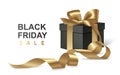 Black gift box with golden bow and long ribbon Royalty Free Stock Photo