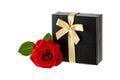 Black gift box with golden ribbon and red rose flower isolated on white background Royalty Free Stock Photo