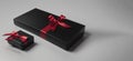 black gift box with red ribbon isolated on red background thanksgiving day