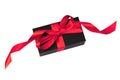 Black gift box with red ribbon on white. Royalty Free Stock Photo