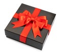 black gift box with red satin ribbon and bow on white background Royalty Free Stock Photo