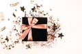 Black gift box with rose gold bow on white background Royalty Free Stock Photo