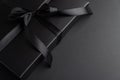 Black Gift Box with Satin Ribbon on Dark Background Royalty Free Stock Photo