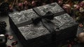 A black gift box set against a dark contrasting background, adorned with a textured bow and feathers Royalty Free Stock Photo