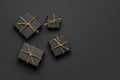 Black gift boxes tied with golden rope on black Royalty Free Stock Photo