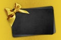 Black gift card with golden ribbon bow, black friday concept