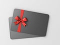 Black gift card with red ribbon and bow on white grey background Royalty Free Stock Photo