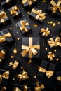 Black gift group with golden ribbons on black background.