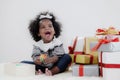 Black girl child playing toy from present box in white room Royalty Free Stock Photo