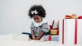 Black girl child playing toy from present box in white room Royalty Free Stock Photo