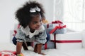 Black girl child playing toy from present box in white room Royalty Free Stock Photo