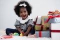 Black girl child playing toy from present box in white room Royalty Free Stock Photo