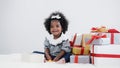 Black girl child playing toy from present box in white room Royalty Free Stock Photo