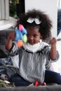 Black girl child playing toy from present box in white room Royalty Free Stock Photo