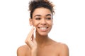 Black girl cleaning her face with cotton sponge Royalty Free Stock Photo