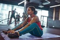 Black girl doing crunching exercise in gym