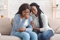 Black girl embracing and comforting her upset friend at home Royalty Free Stock Photo