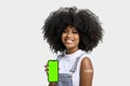 Black girl without face shield holds the cell phone close to her arm with the vaccine sticker, fully immunized, chroma key on the