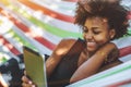 Black girl in hammock with digital pad Royalty Free Stock Photo