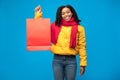 Black Girl Holding Shopping Bag Standing Over Blue Studio Background Royalty Free Stock Photo