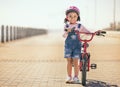 Black girl, learning and bike for portrait, smile or park path with sunshine, safety or happiness. Kid, happy and Royalty Free Stock Photo