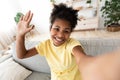 Black Girl Making Selfie Waving Hello To Camera At Home