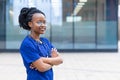 Black girl medical student in glasses, happy young african american woman doctor in blue uniform, stethoscope, Royalty Free Stock Photo
