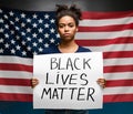 Black girl protesting with poster Black Lives Matter