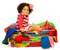 Black girl sitting in the basket with clothes