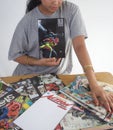 Black girl reading a collection of comics