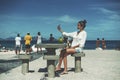 Black girl taking selfie near beach area with people around Royalty Free Stock Photo