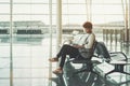 Black girl using smartphone in waiting room of airport Royalty Free Stock Photo